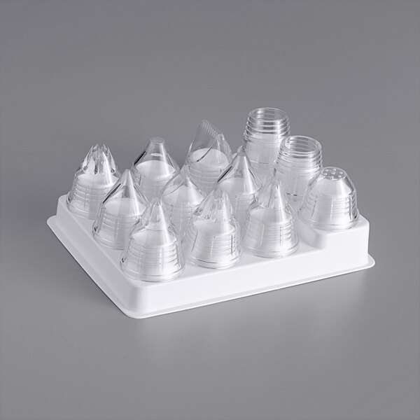 A clear plastic container with a cone shaped top holding a Matfer Bourgeat 10-piece pastry tip set.