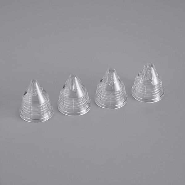 A clear plastic cone shaped container holding Matfer Bourgeat interchangeable pastry tips.