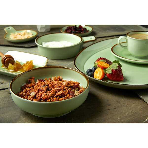 An oval platter with bowls of food on a table.