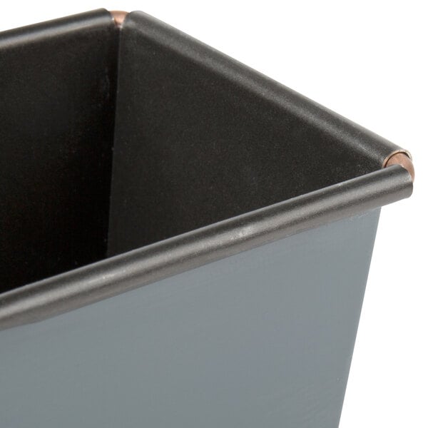 A close-up of a black metal Matfer Bourgeat bread loaf pan.