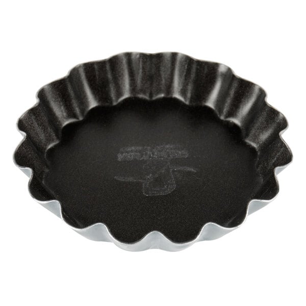 A black fluted tartlet mold.