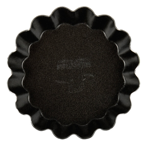 A black Matfer Bourgeat fluted tartlet mold.