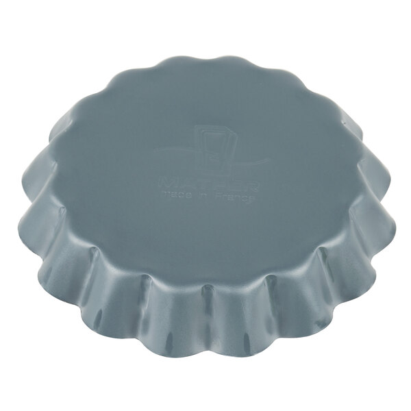A Matfer Bourgeat fluted steel tartlet and quiche mold.