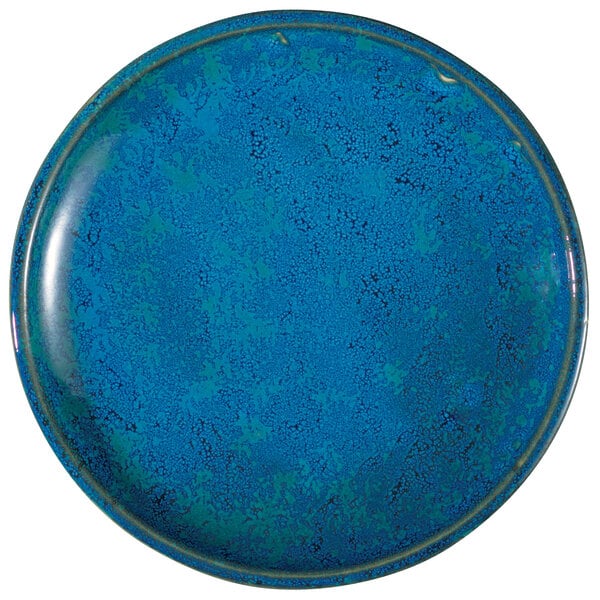 A blue Oneida Studio Pottery porcelain plate with specks.