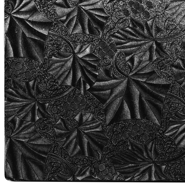 A black Enjay square cake drum on a black and white patterned surface.