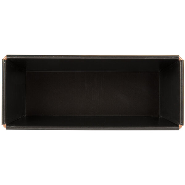 A black rectangular bread loaf pan with a brown edge.