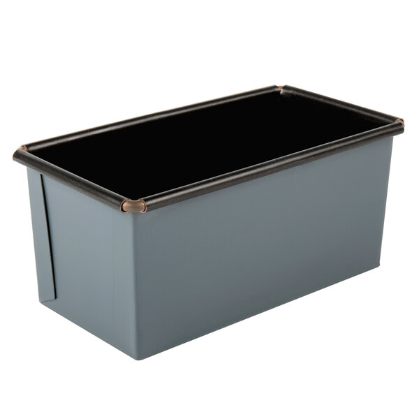 A rectangular metal loaf pan with black edges.