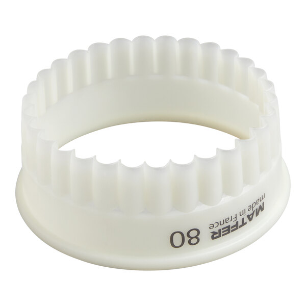 A white, round, fluted plastic pastry cutter with a scalloped edge and the number 80 printed on the side.