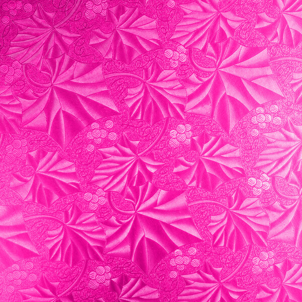 A close up of a pink patterned plastic Enjay round cake drum.