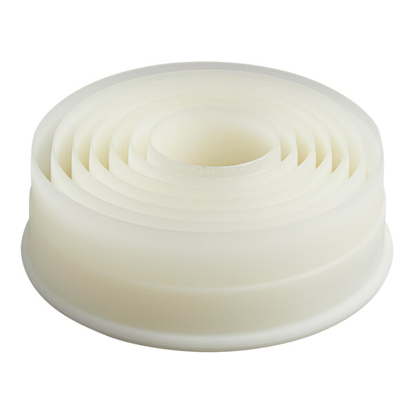 A stack of round, white, nested pastry cutters of varying sizes.