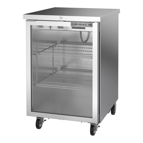 A stainless steel counter height back bar refrigerator with a glass door and two wire shelves.