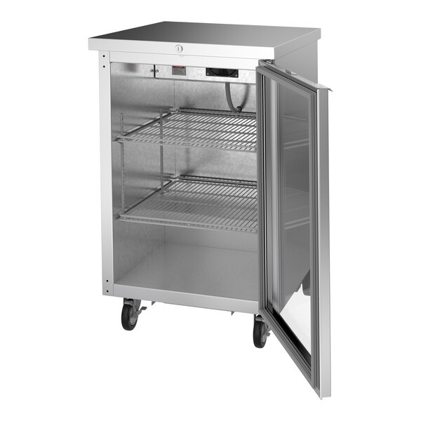 A stainless steel counter height back bar refrigerator with a glass door and wire shelves.