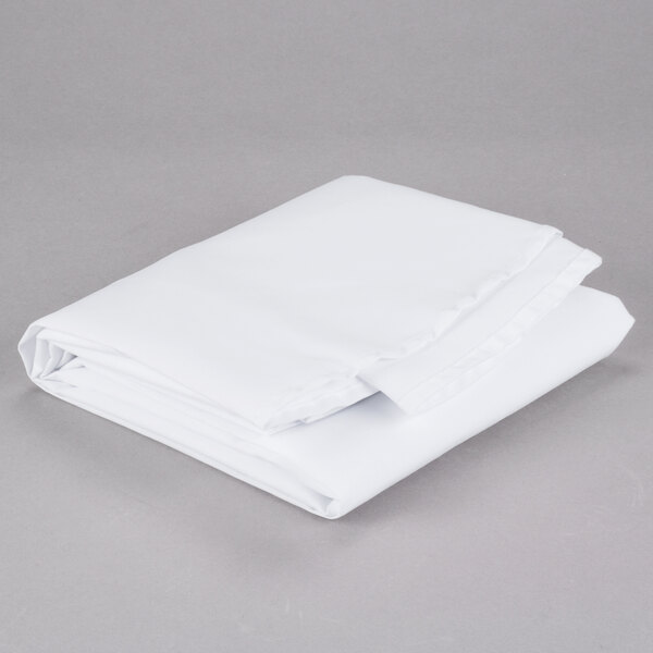 A folded Intedge white poly/cotton table cover on a gray surface.
