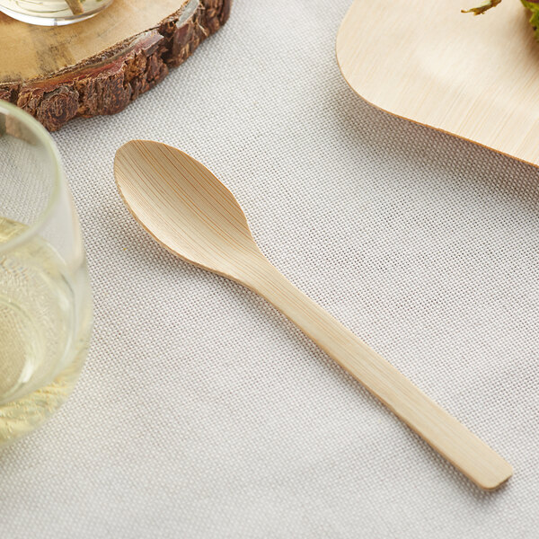 A Bamboo by EcoChoice compostable wooden spoon on a table.