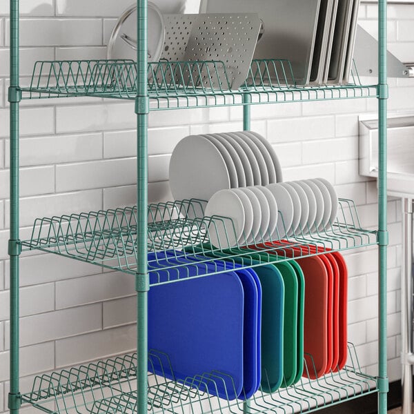 A Regency green wire rack with plates on it.