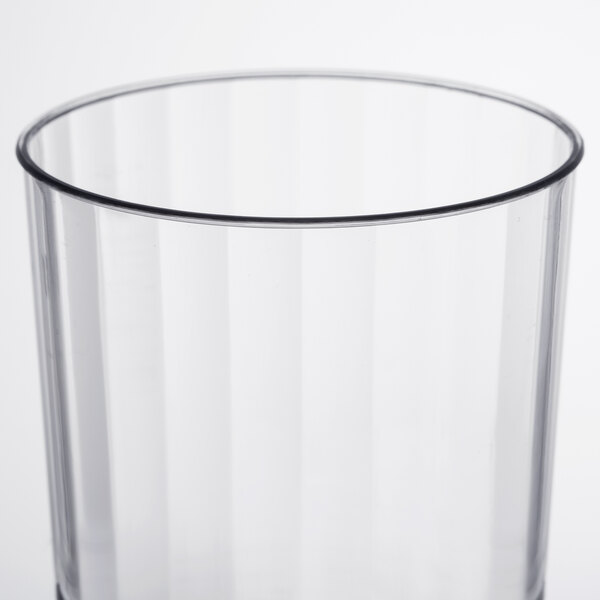 A clear plastic pedestal wine cup with a black rim.