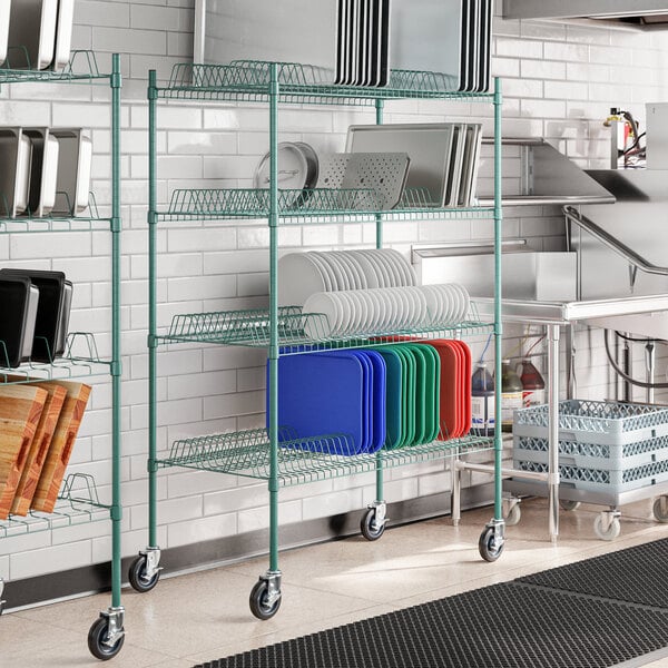A green Regency wire rack with trays on it.
