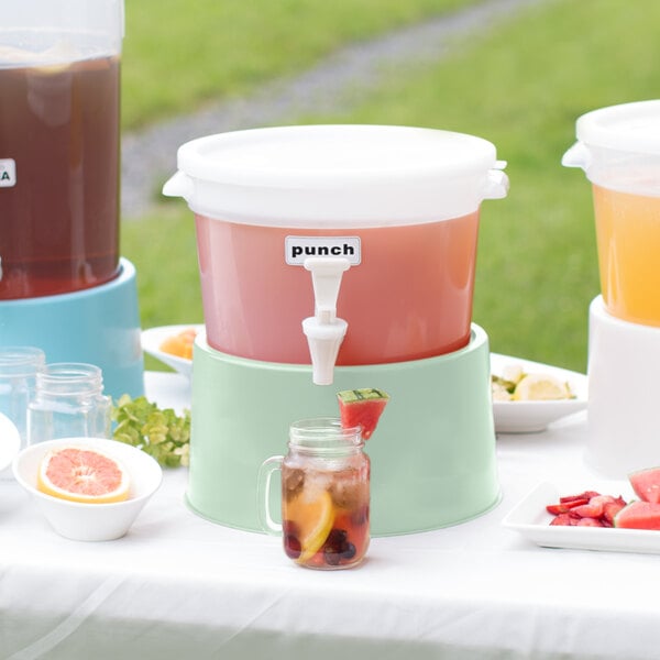 A Choice white plastic beverage dispenser with cucumber water on a white table.