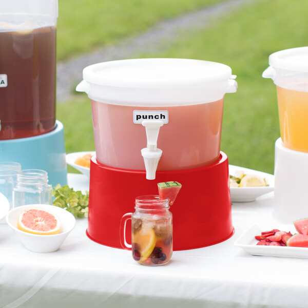 A white Choice plastic beverage dispenser with a red base on a table with drinks.