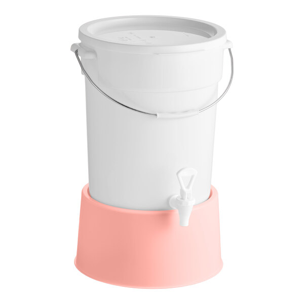A round 6-gallon white beverage dispenser with a rose-colored base and a spigot.