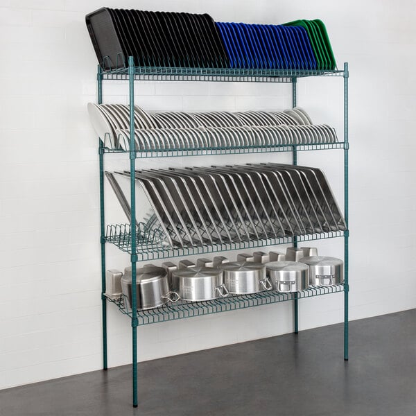 A Regency wire shelving kit with green epoxy shelves, holding white plates and pots.