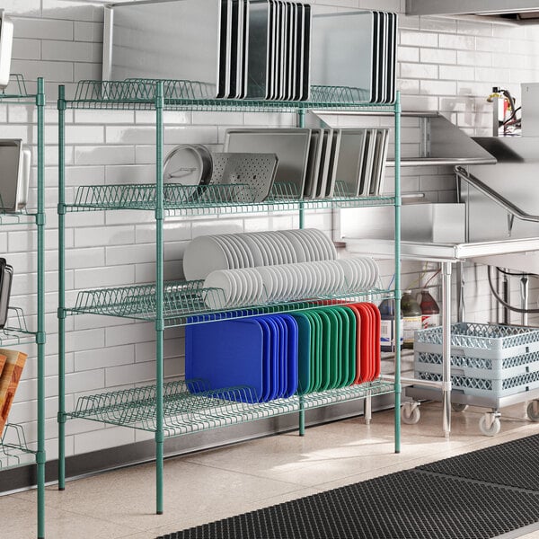 A metal wire rack with green shelves and metal posts.