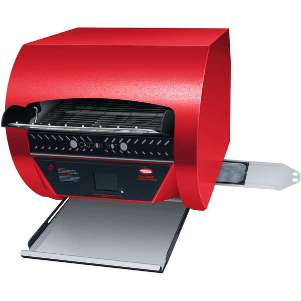 A red and black rectangular Hatco conveyor toaster with a black panel on a counter.