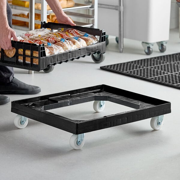 A person using an Orbis bakery tray dolly to transport bread