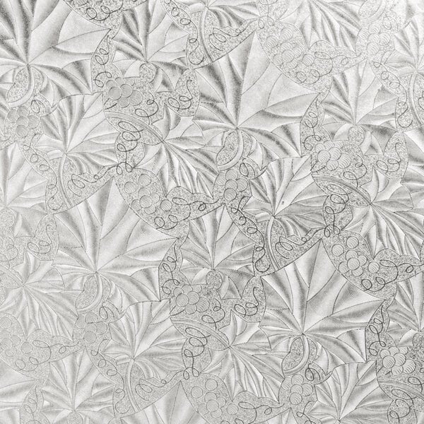 A white and silver Enjay round cake drum with a leaf pattern.