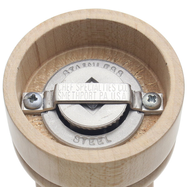 A Chef Specialties Natural Maple pepper mill on a table in a professional kitchen.