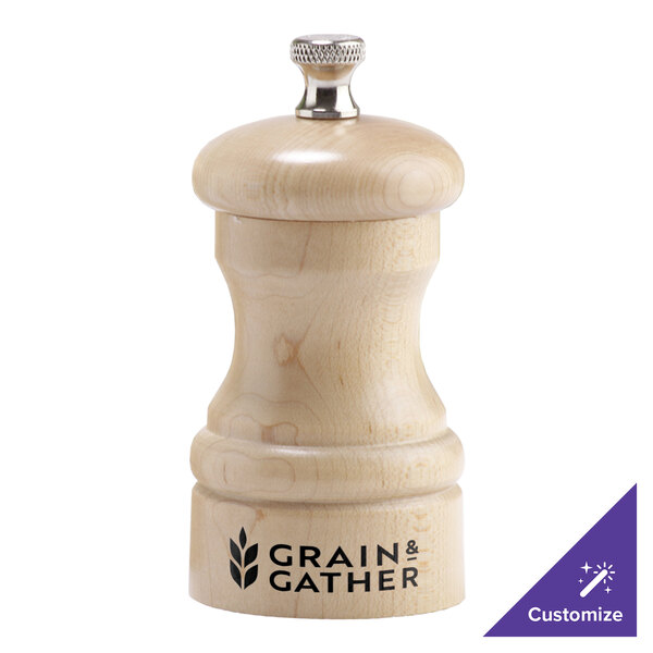 A wooden pepper mill with a silver lid.