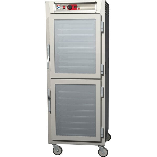 A white Metro C5 series holding cabinet with clear Dutch doors.