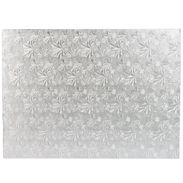 A white glass Enjay cake board with a pattern of flowers on it.