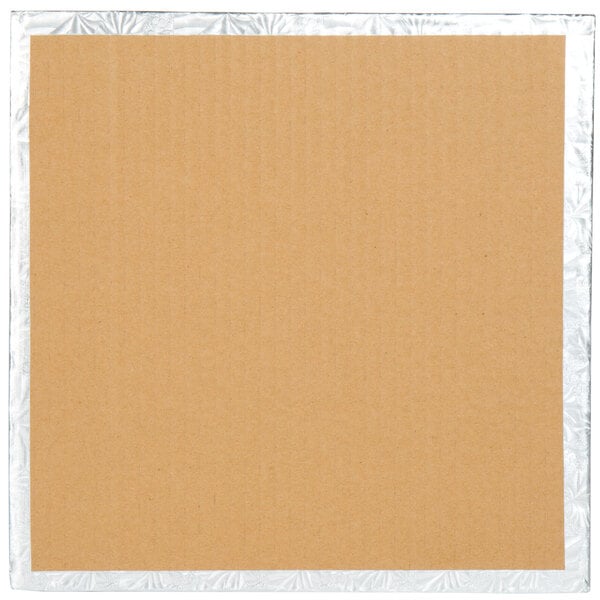 A white cardboard square with silver foil on it.