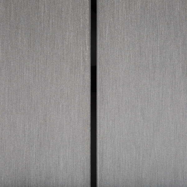 A close up of a synthetic teak wood slat table top on a grey surface.