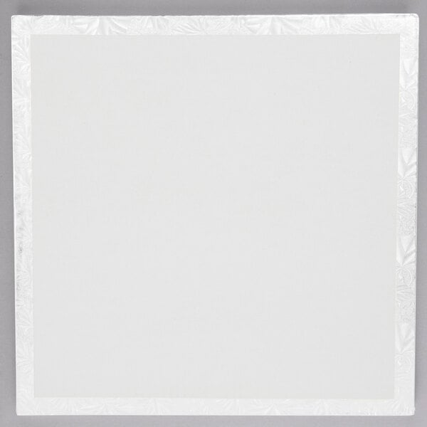 A white square cake drum with a white border.