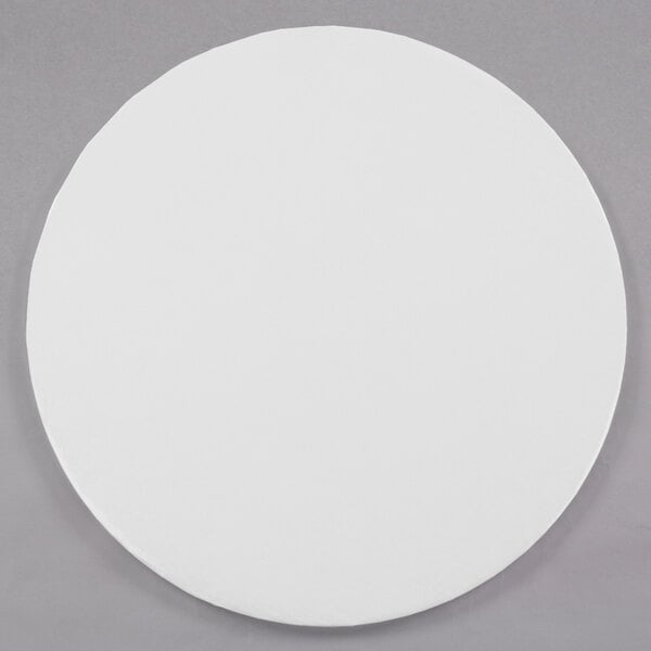 An Enjay white round  cake drum.