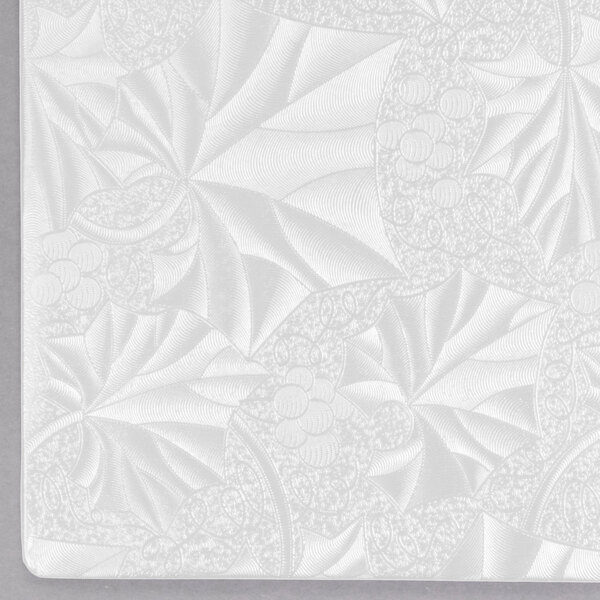 A white square Enjay cake board with a pattern of leaves.