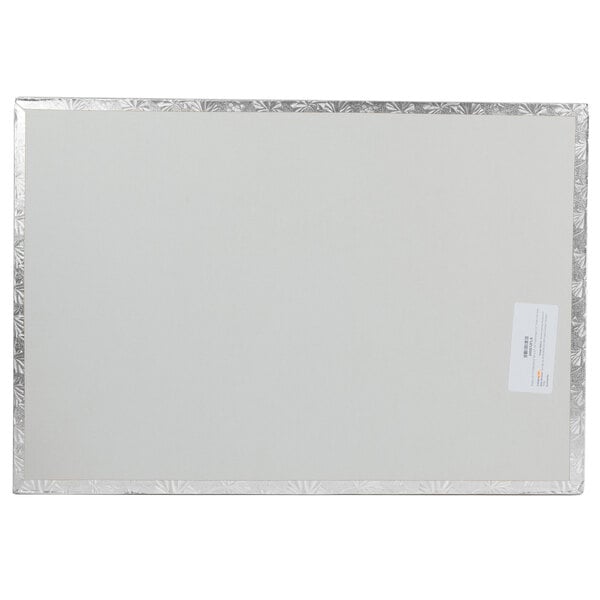 A white rectangular Enjay cake board with silver trim.