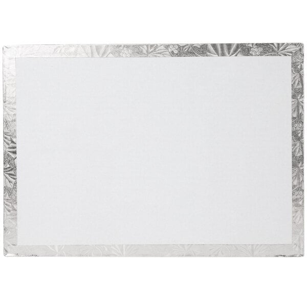 A white rectangular cake board with a silver border.