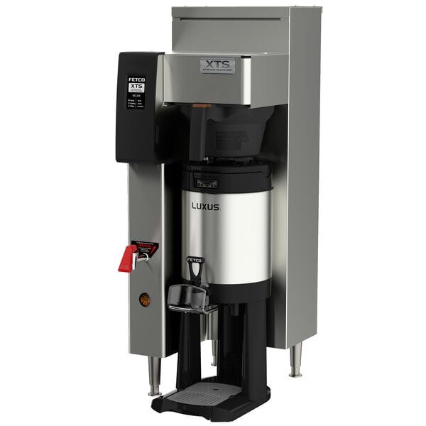 A Fetco stainless steel automatic coffee brewer with a black and silver handle.