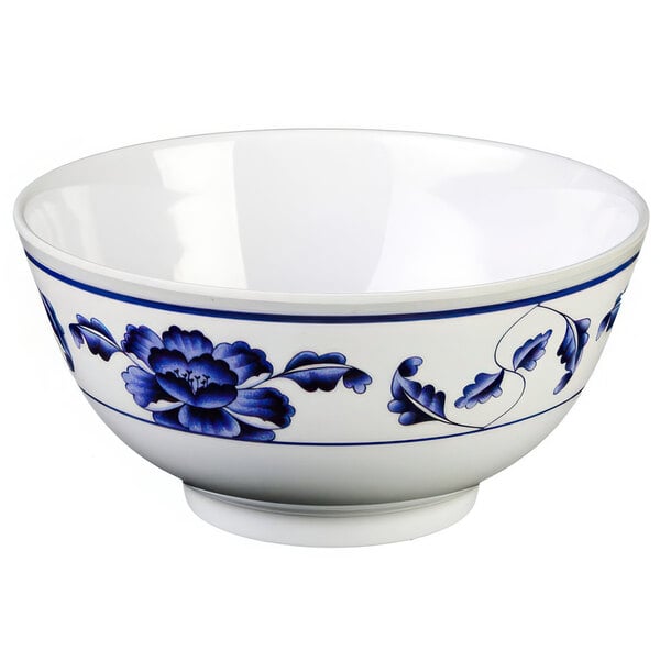 A white Thunder Group melamine rice bowl with blue flowers on it.