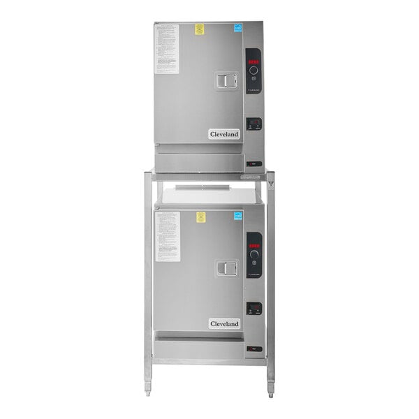 A Cleveland SteamChef 6 double deck electric floor steamer on a stand with two ovens.