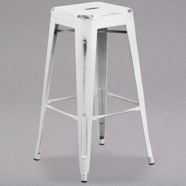 A Flash Furniture white metal bar height stool with a square seat and legs.