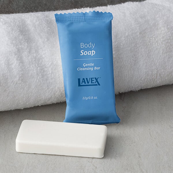 A blue package of Lavex wrapped body soap next to a white towel.