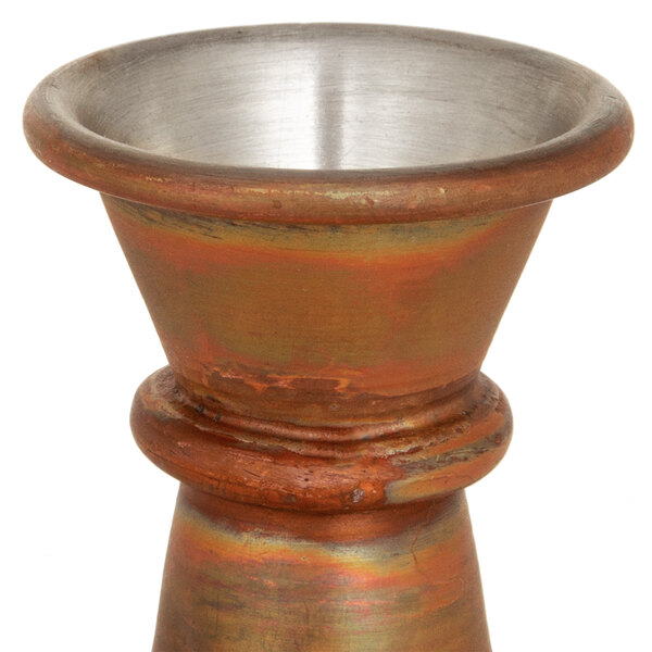 An American Metalcraft antique copper Japanese style jigger with metal bowls on a table.