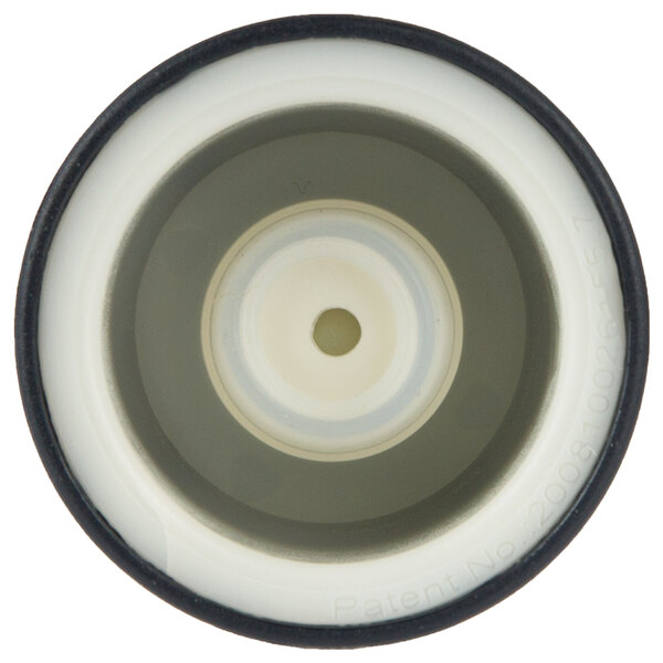 A close-up of a white and black circular wine pump and stopper.