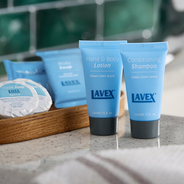 A group of blue Lavex Hotel and Motel Shampoo bottles on a counter.