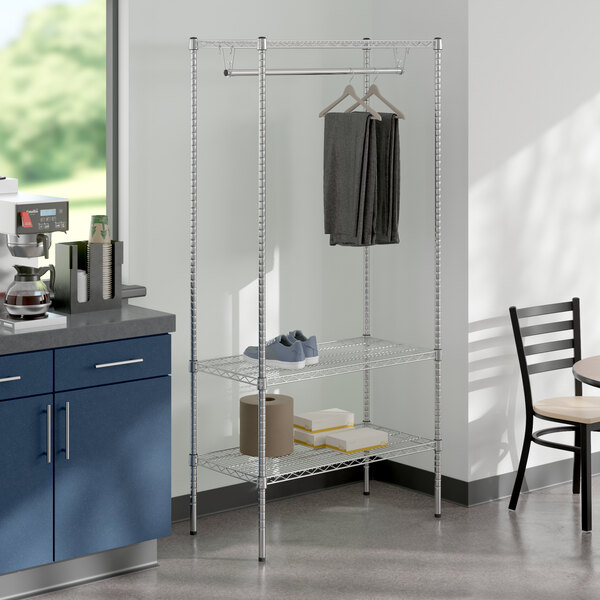 A kitchen with a table and a rack with Regency chrome garment rack on it.