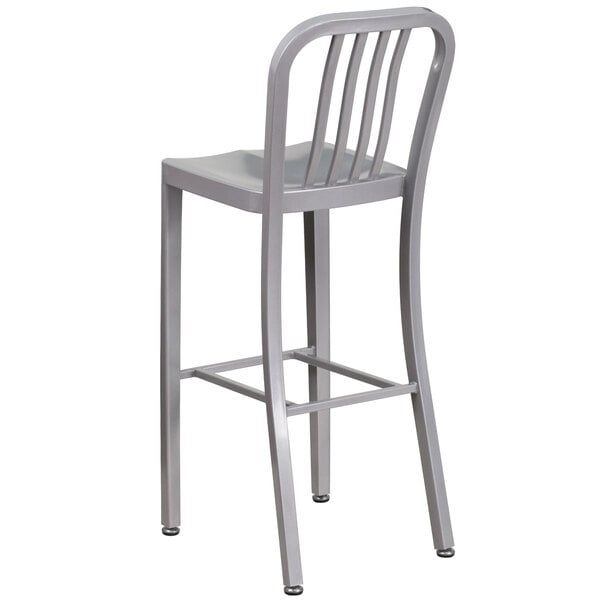 A silver metal bar stool with a backrest.